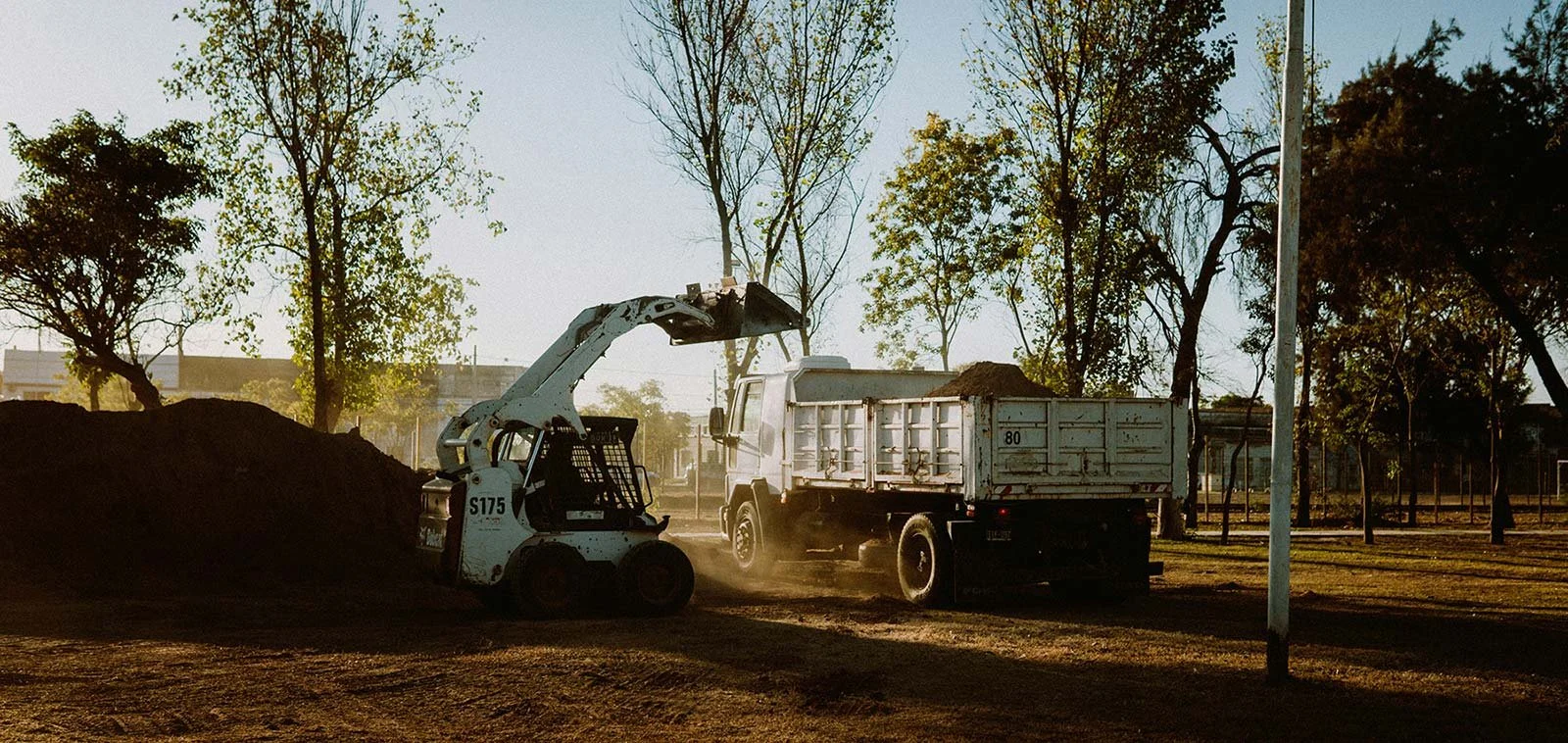 Backhoe loading a dump truck