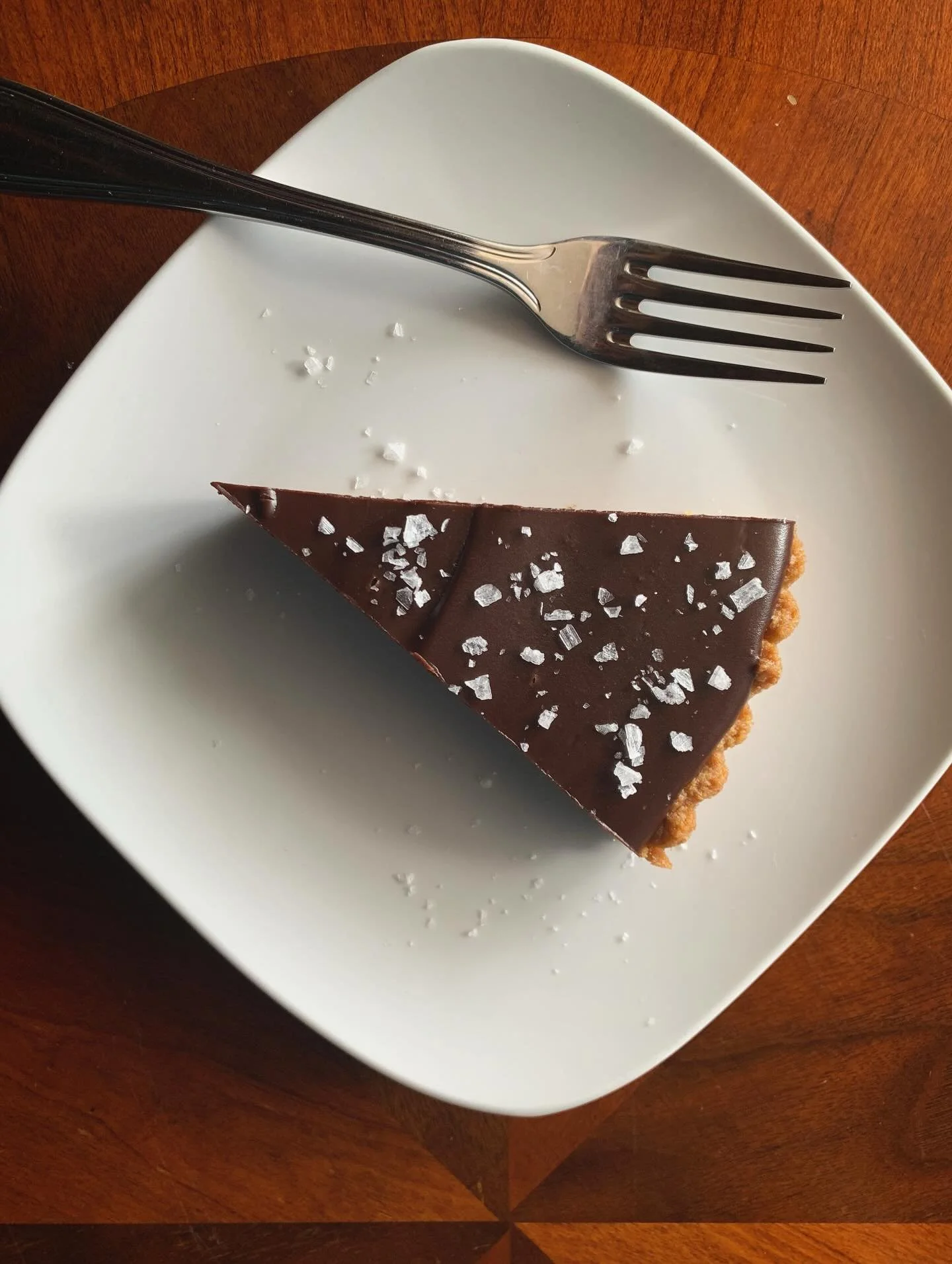 Chocolate Ganache Tart is back! 
.
Rich Dark Chocolate with a Gluten Free* Gingerbread Cookie Crust, sprinkled with Sea Salt.
.
Pair it with a glass of wine or a French Press Coffee&hellip;and a puzzle.
.
Open LATE:
Wed 3:30-10pm
Thurs 3:30-10pm
Fri 