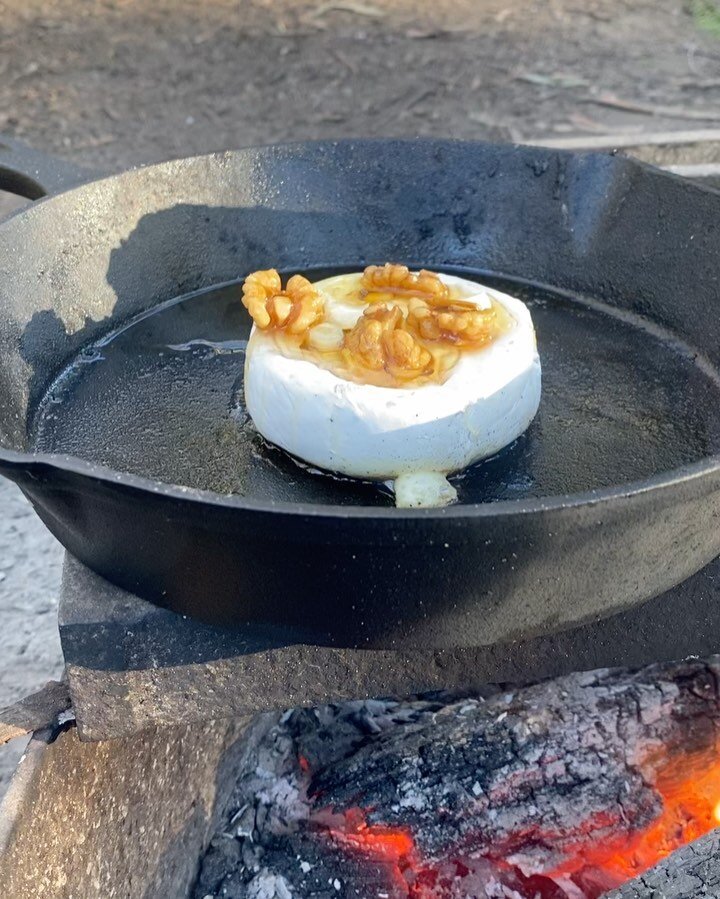 Elite fire cheese 🔥🪵 🫕 

Throw some garlic and or hard herbs like rosemary into the top of the cheese wheel, pour some honey over top and melt over the fire like so. 

We used @bilpin_bush_honey with walnuts to elevate to elite levels. 🤤 

Then w