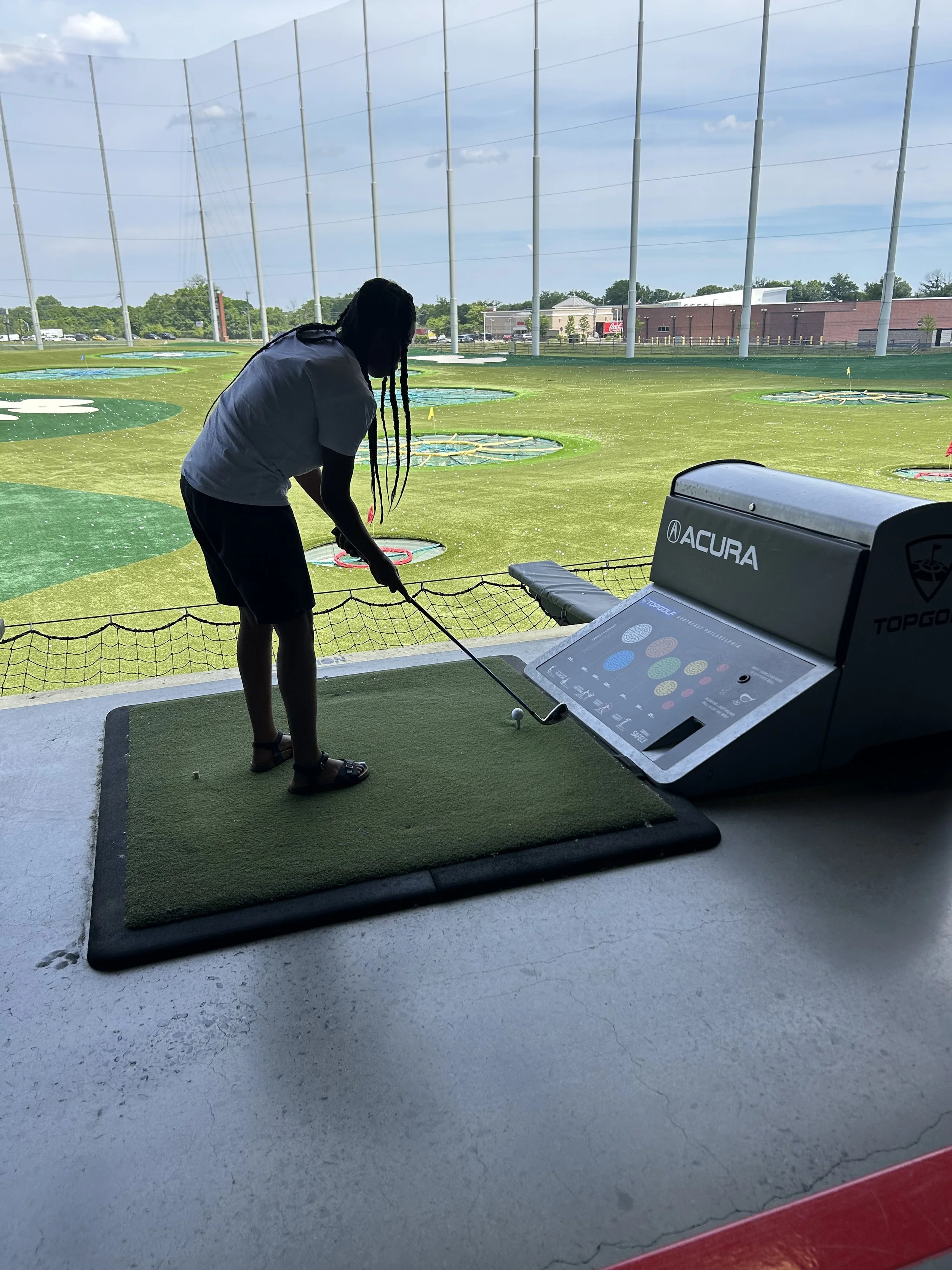 Laurie’s customers, Mariana and Carmen holding hands on a green lawn on their wedding day.