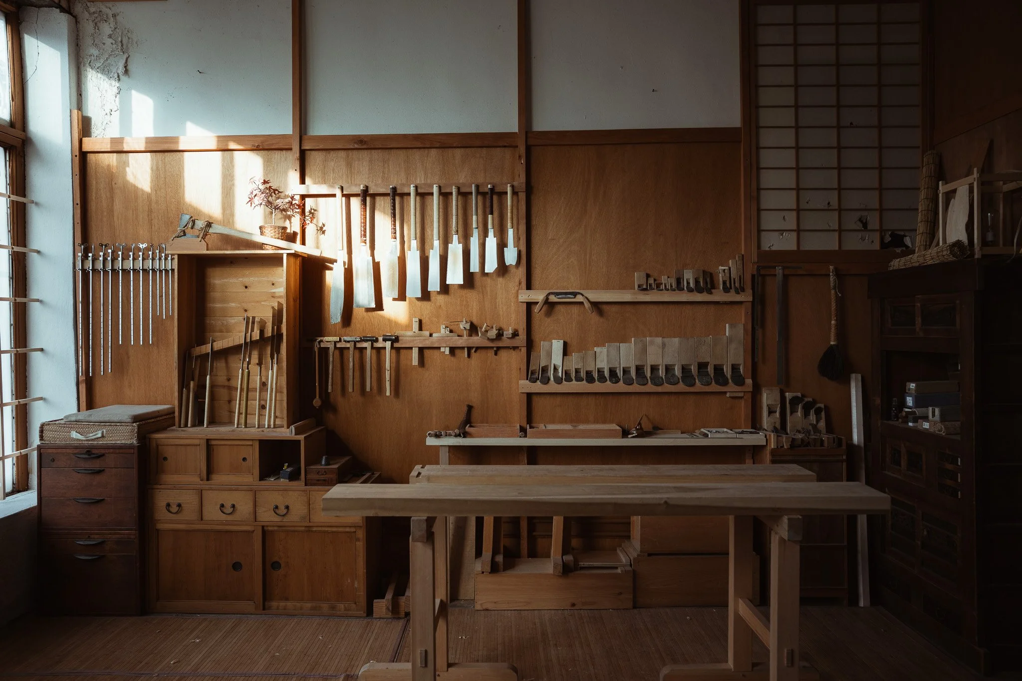 This image shows a woodworking studio full of japanese hand tools, a traditional japanese hand tool studio in New York City area