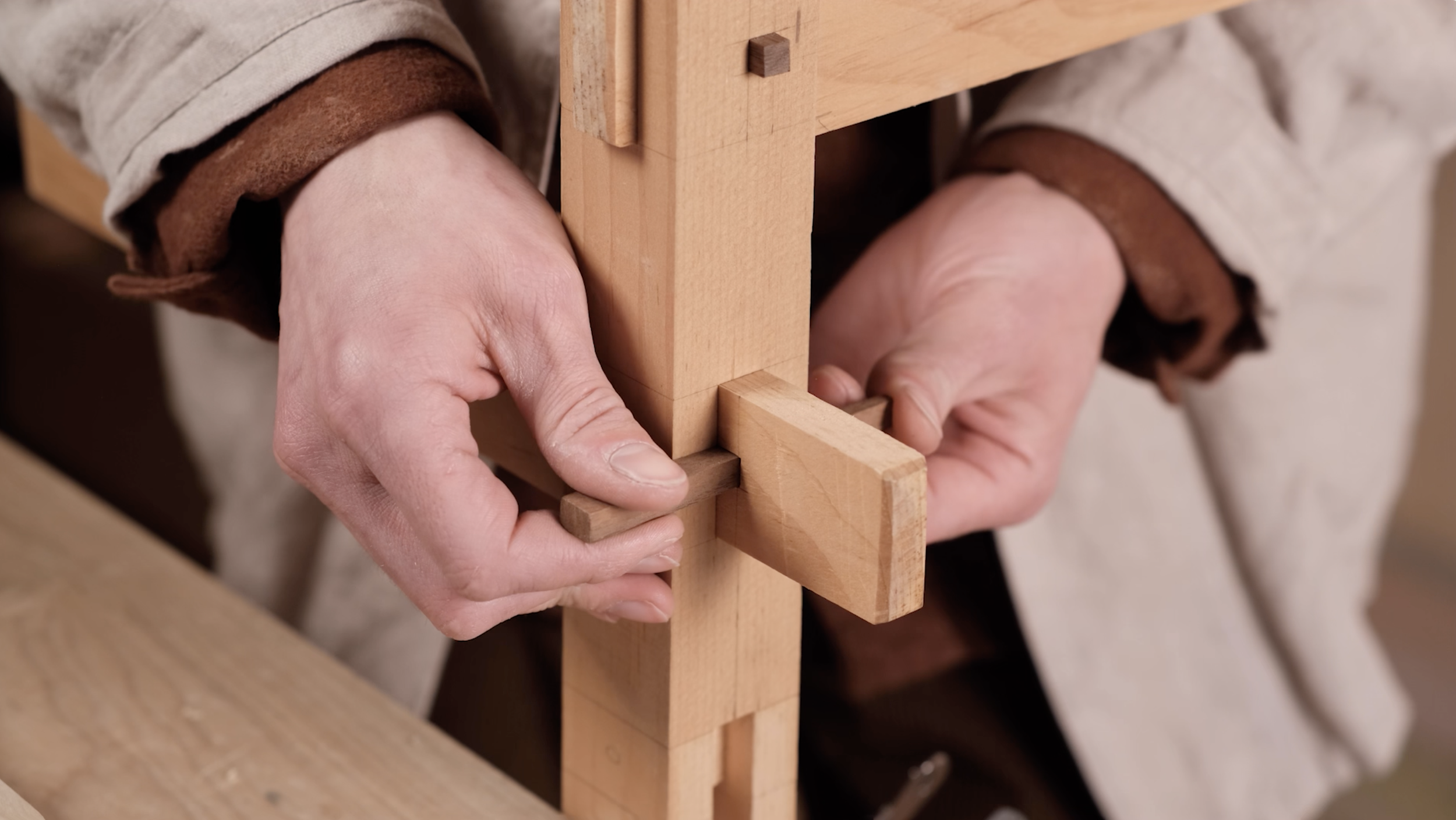 Person assembling a wooden japanese joinery. 