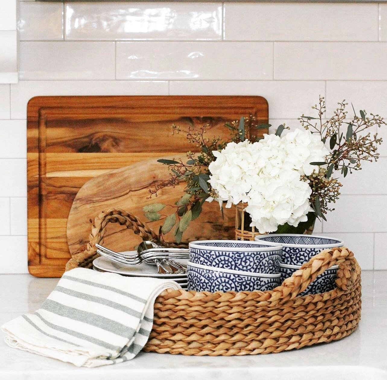 Styling your kitchen doesn't have to be hard. Gathering a few pretty things on a seagrass tray does wonders. Make sure to add some flowers to bring in spring. Don&rsquo;t be a afraid to change it up with each season. 💙  #kitchenstyle #kitchenstyling