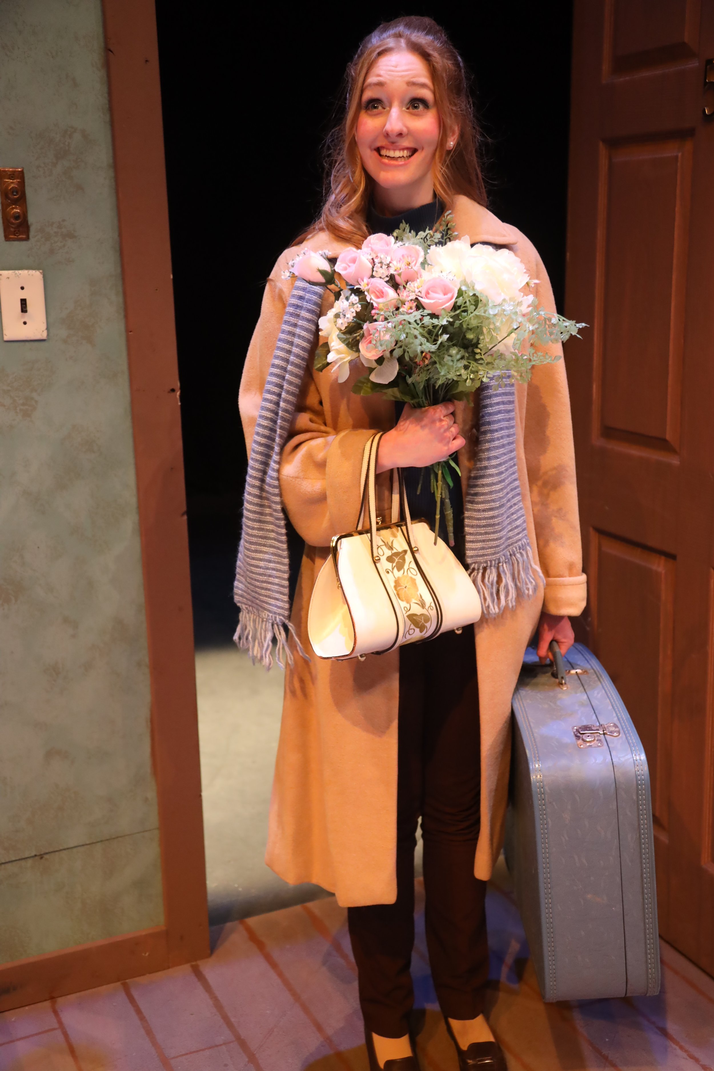 Corrie Bratter with bags and floral arrangement