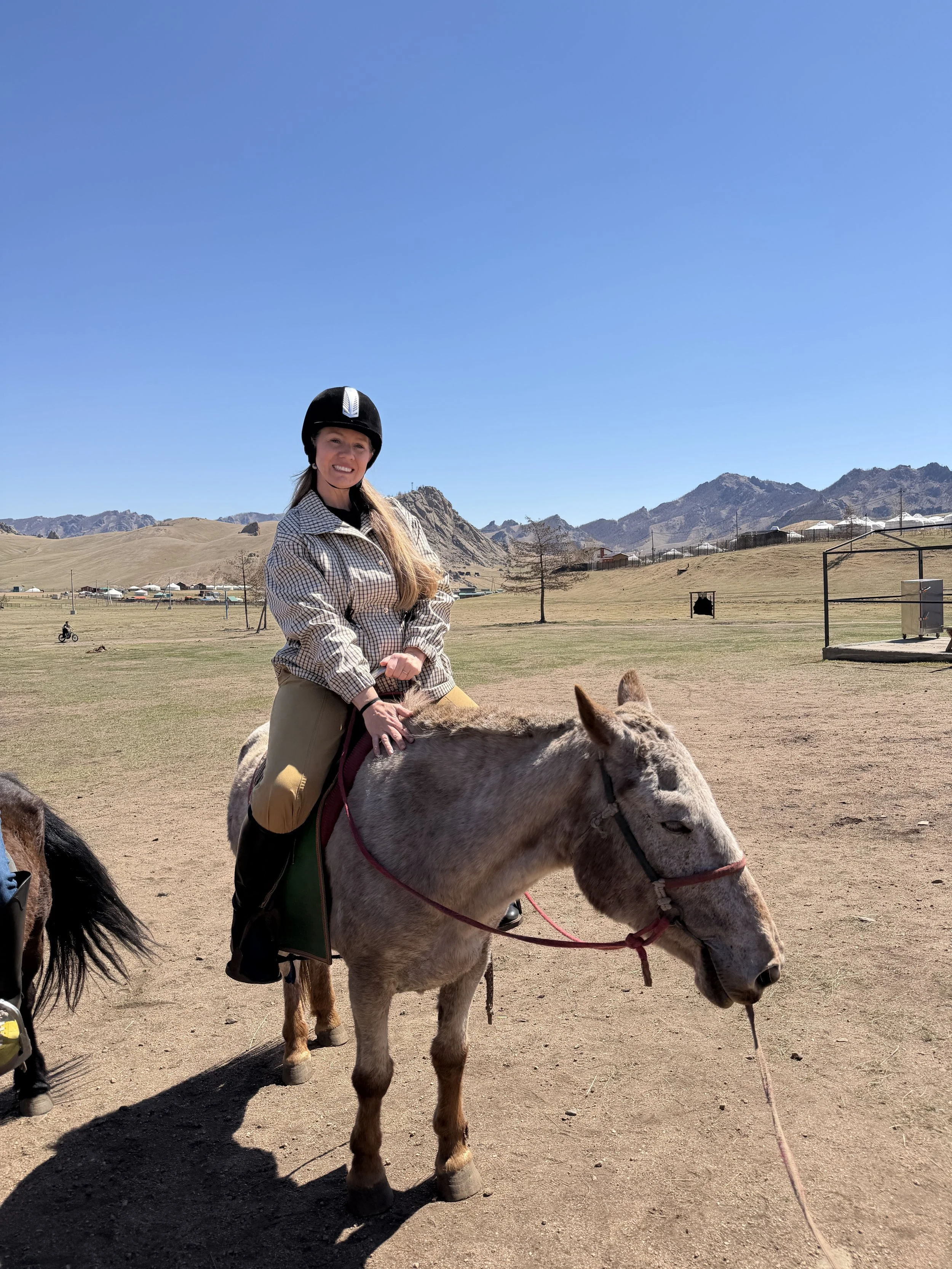 Woman riding a horse in Mongolia