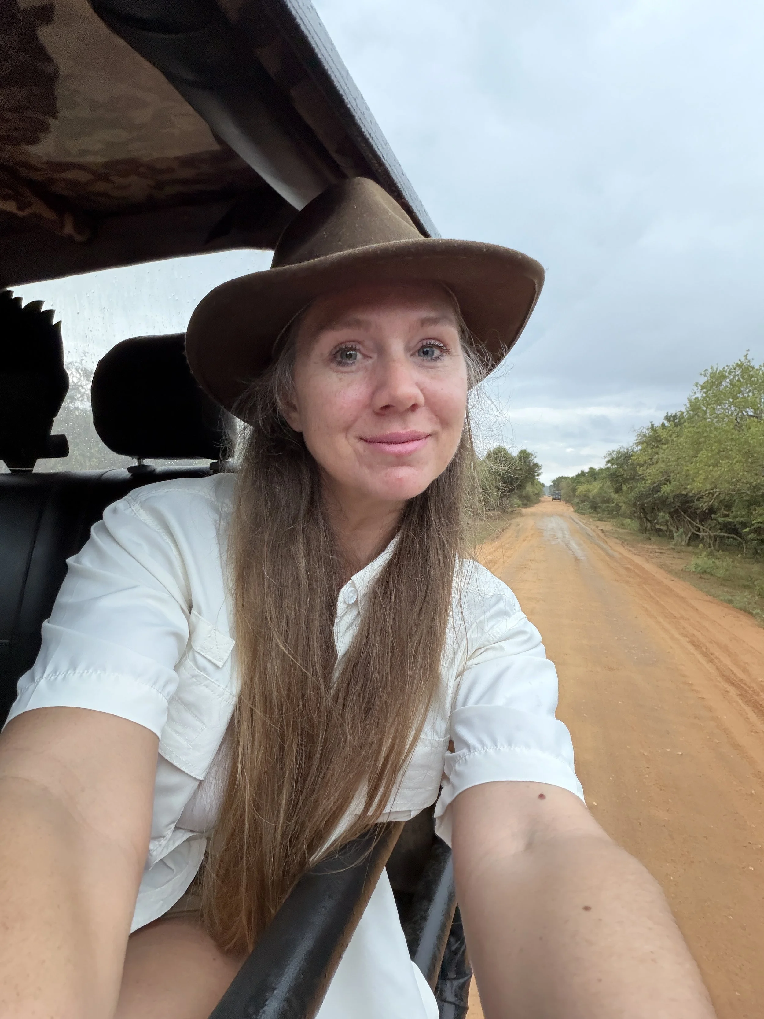 hanging out the window of safari jeep.JPG