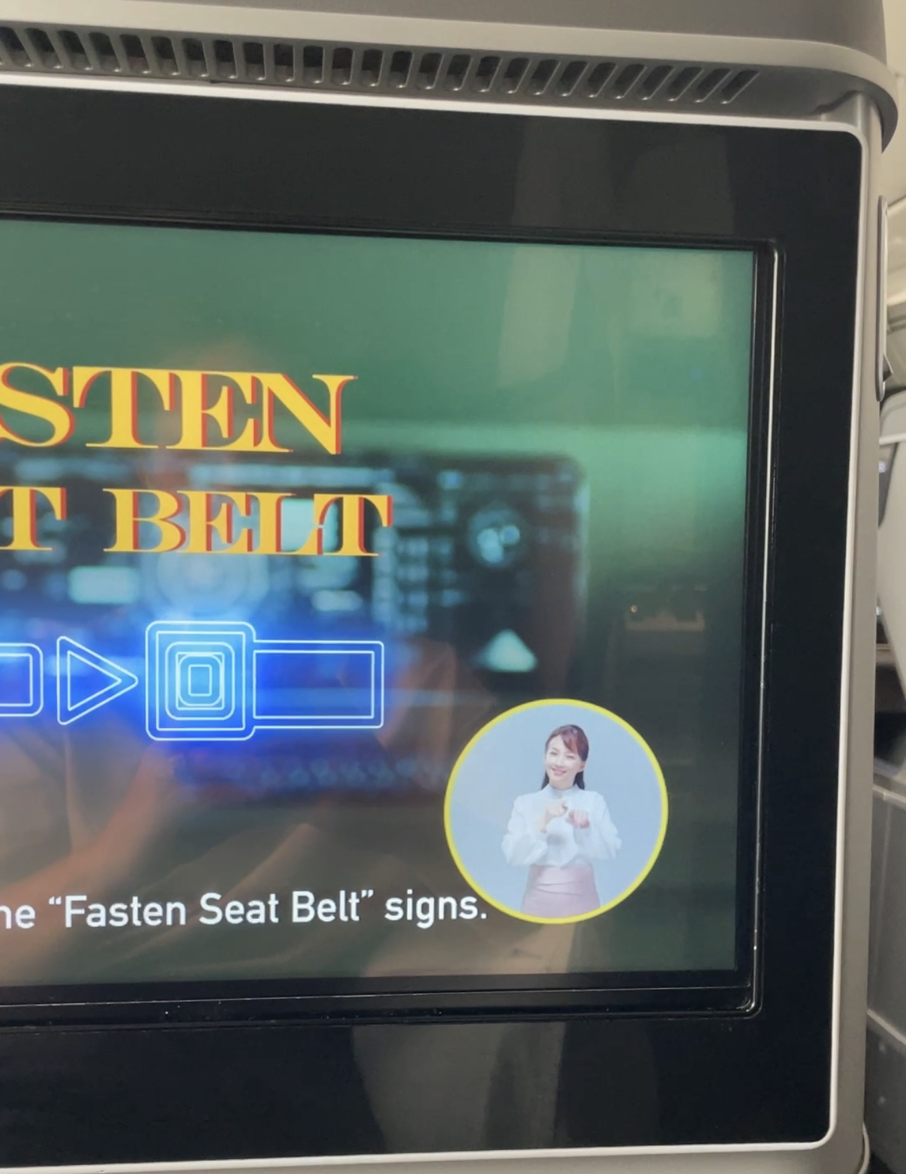 EVA Air Royal Laurel Business Class seat screen showing safety video with sign language interpreter on Boeing 787