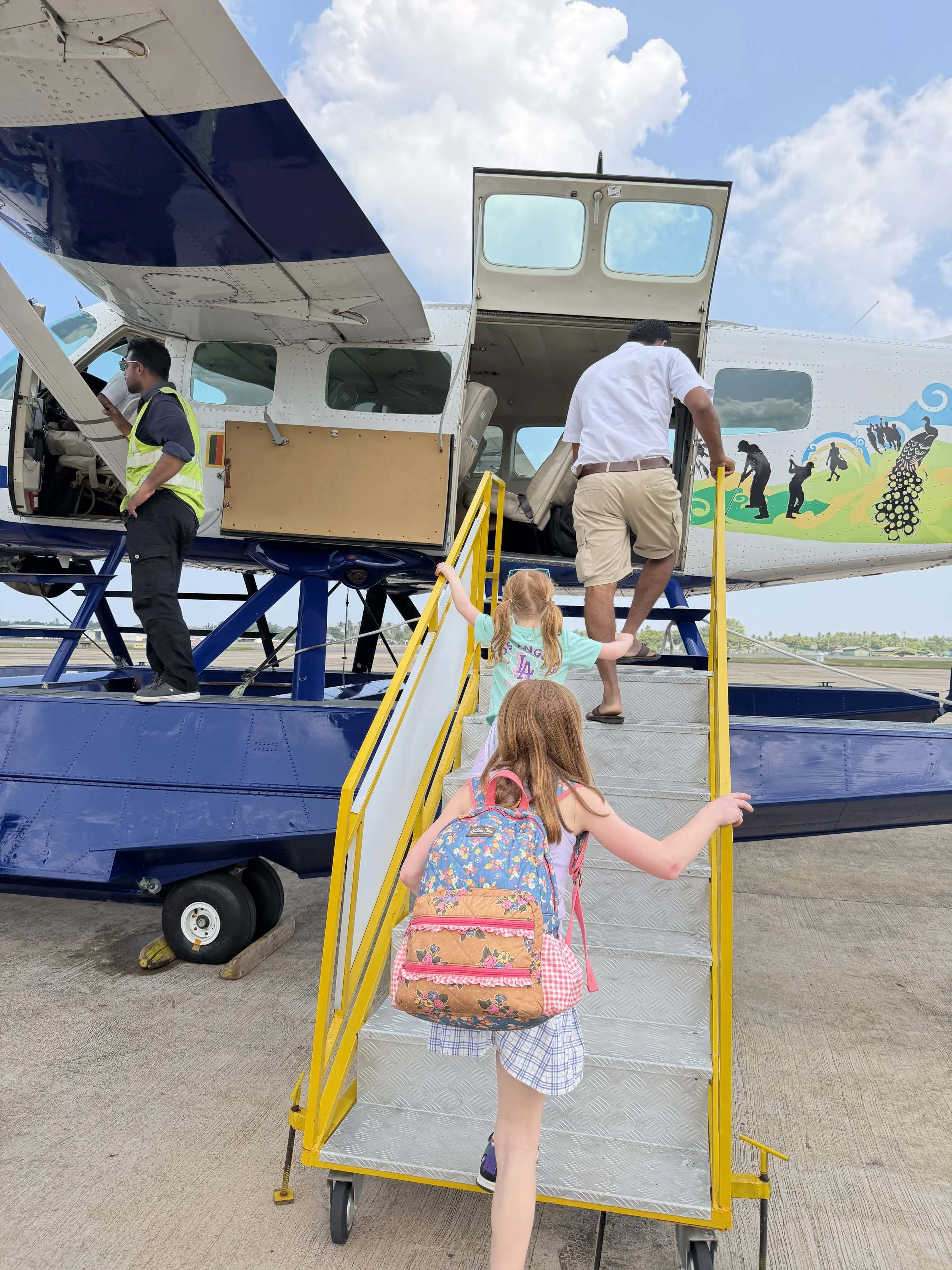 Family boarding a Cinnamon Air seaplane before flying from Colombo to Weerawila in Sri Lanka