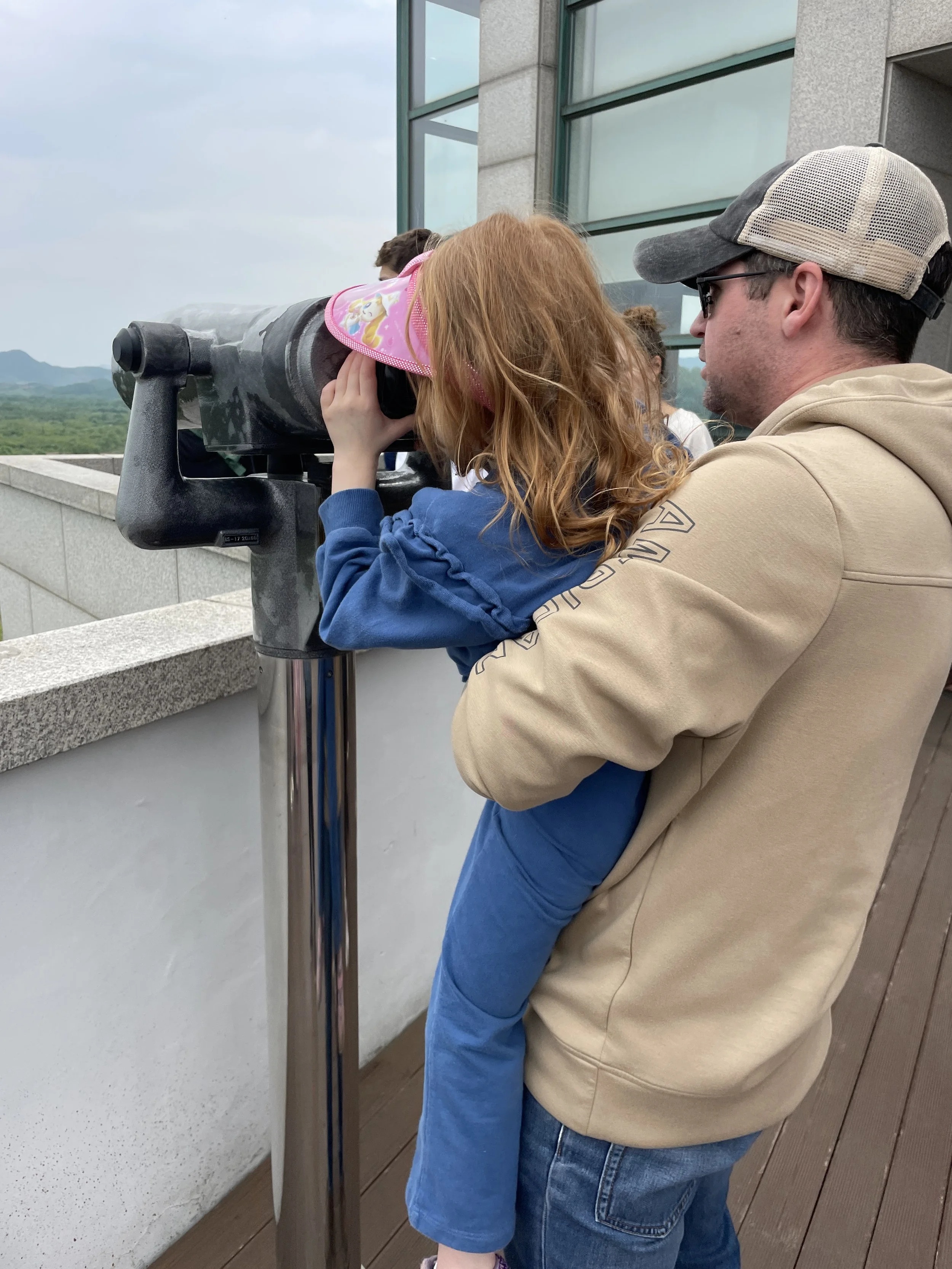 father and daughter using the binoculars at cheorwon observatory north korea south korea.JPG