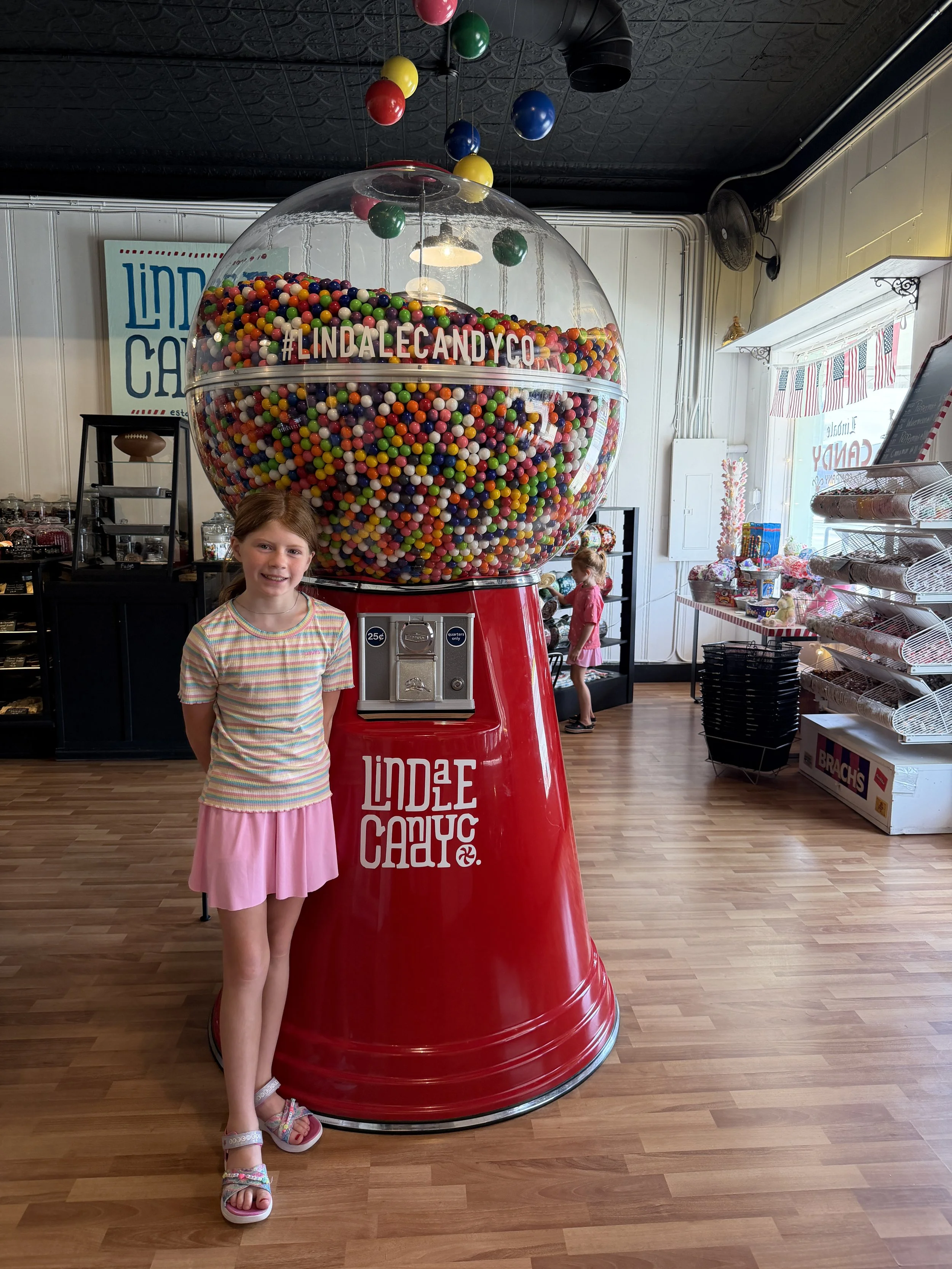 london in front of the giant gumball machine lindale candy co.JPG