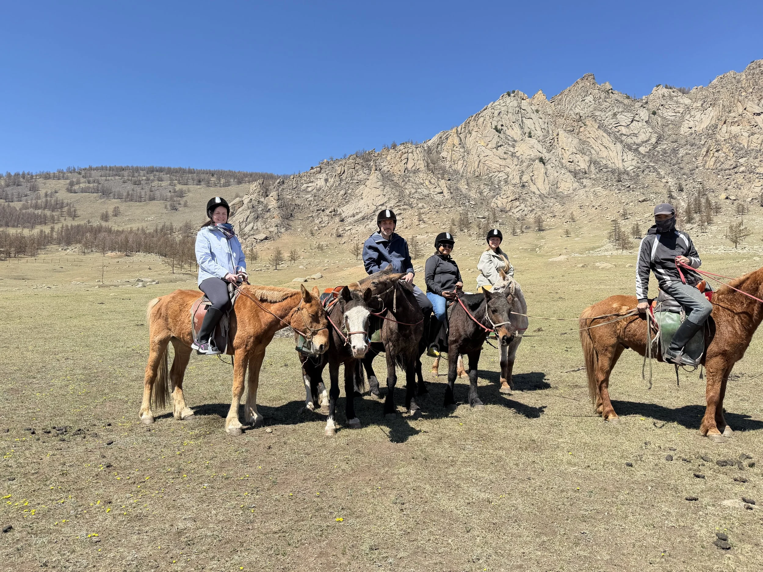 group of foreigners riding horses in Mongolia