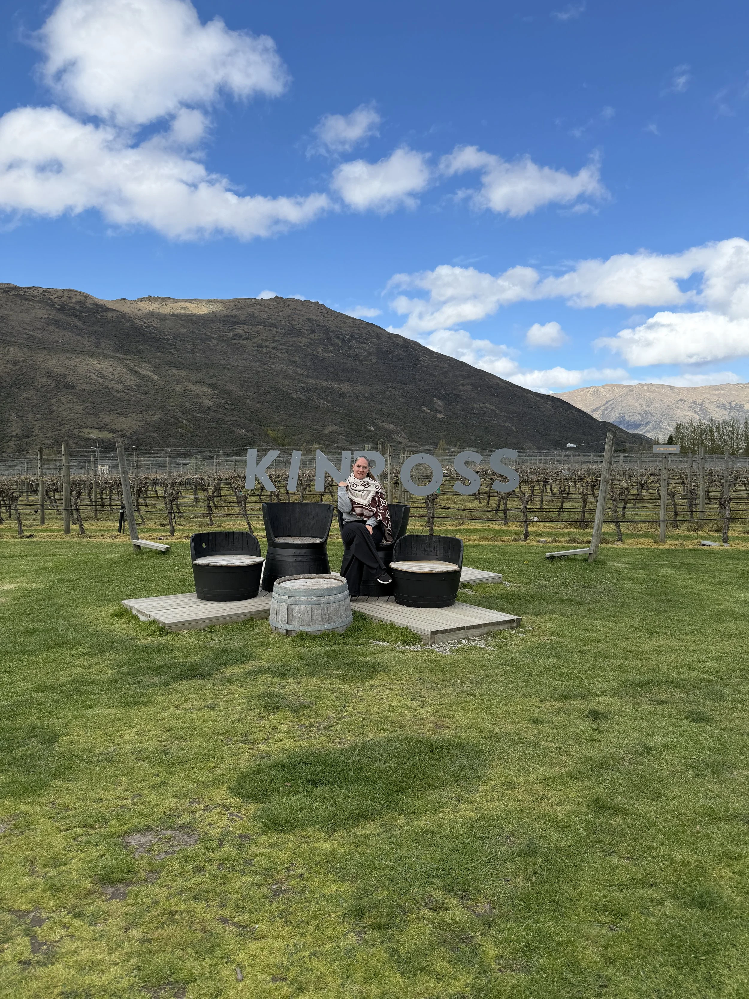In front of the Kinross sign in Queenstown, New Zealand