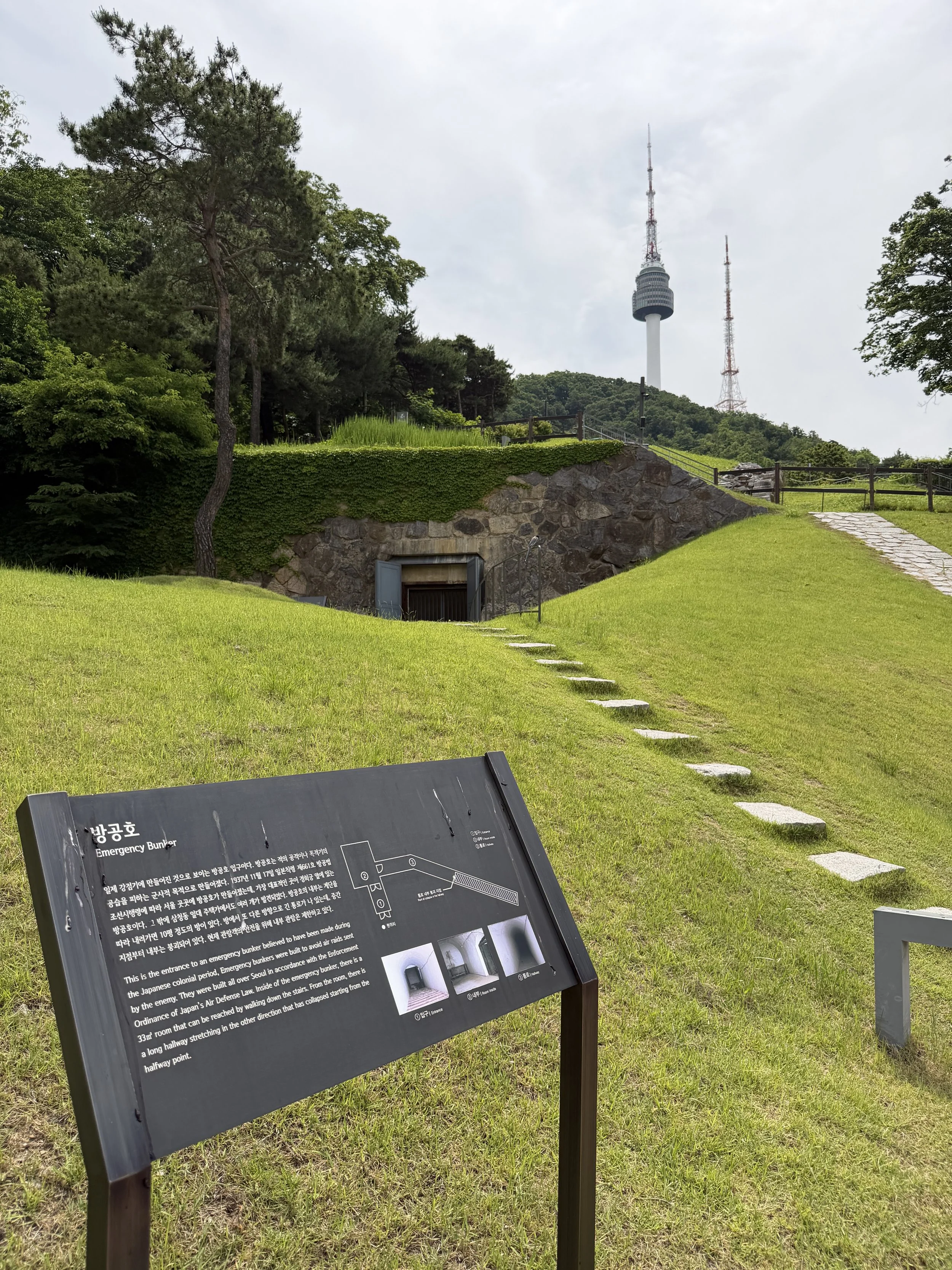 namsan tower and emergency bunker with sign.JPG