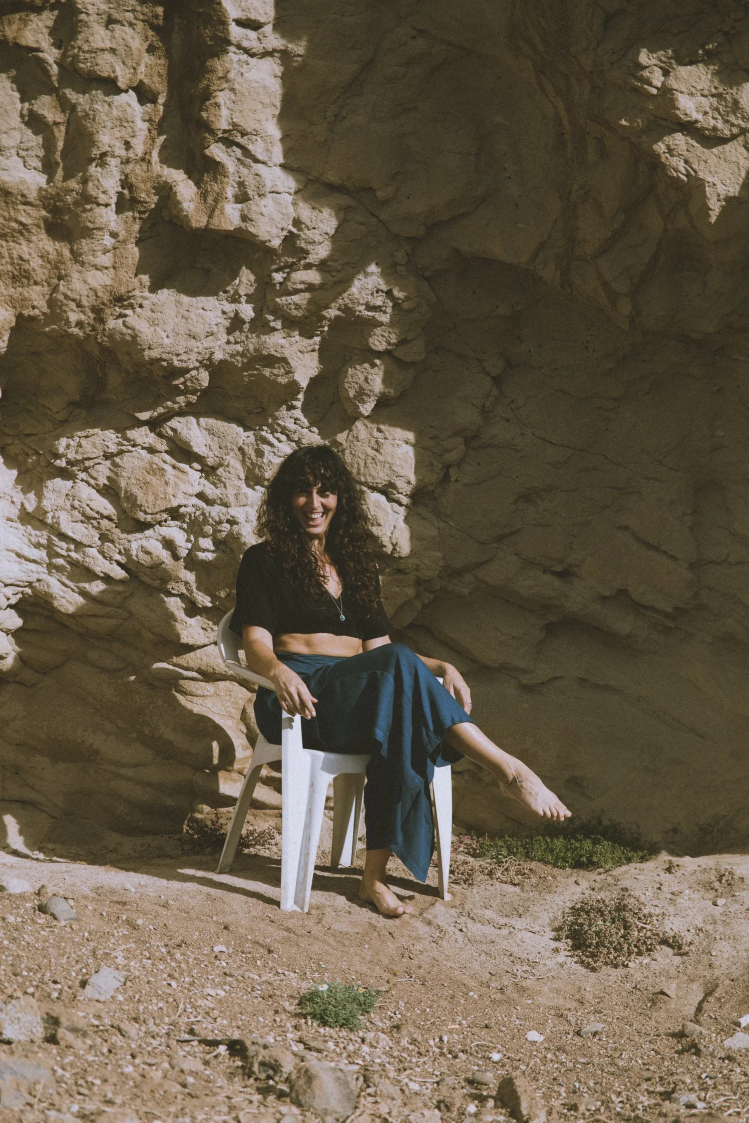 Lydia sentada en una cueva de piedra