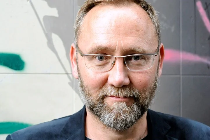 Miles Evans (man's face with beard and glasses)