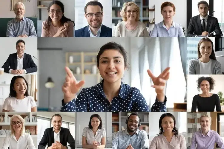 Virtual meeting with diverse group of people on a video call, smiling and engaging.