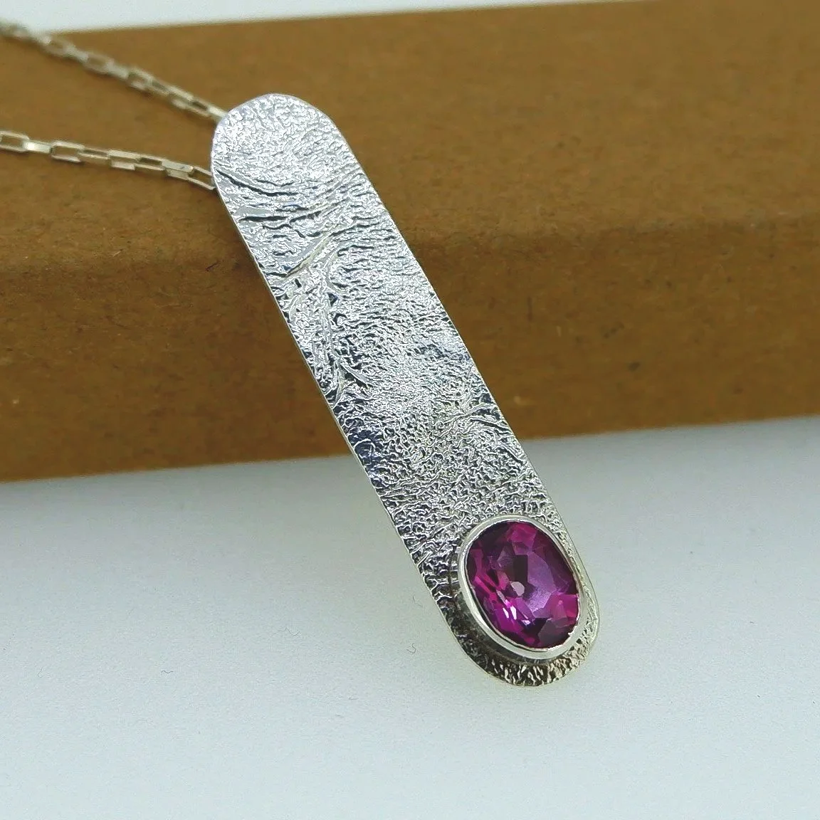 Pink topaz against a reticulated texture