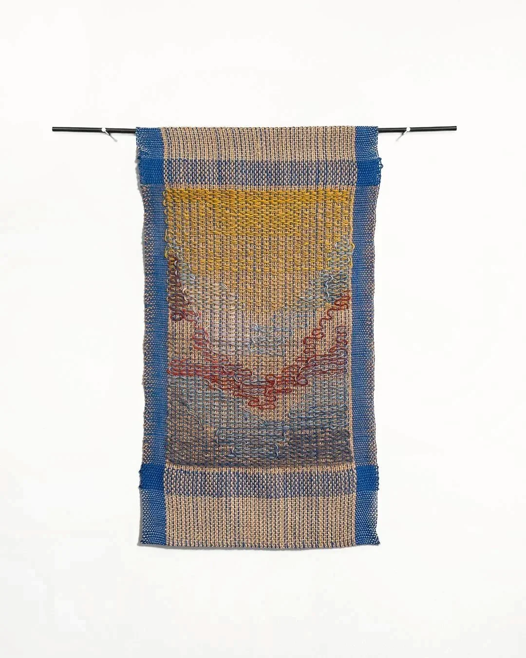 small tapestry in gold, red, and blue