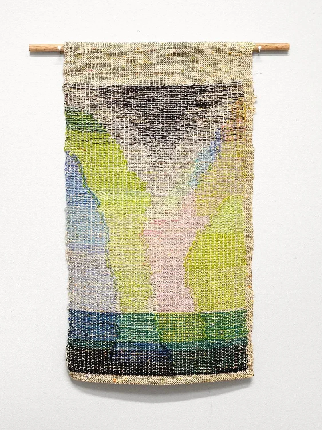 small tapestry with pink and green