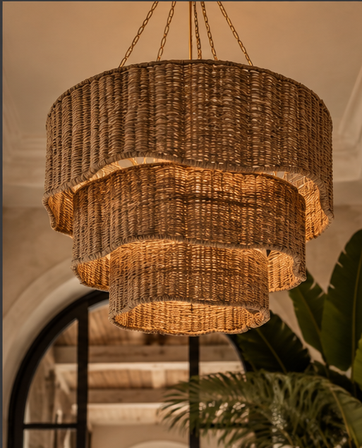 An oversized woven chandelier introduces warmth, movement, and sculptural drama. Natural texture meets statement lighting, setting the mood from the moment you enter.