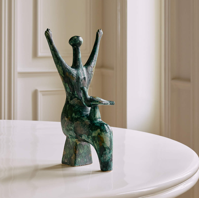 La Pace Ceramic Sculpture from CB2. Raised arms and a mottled green glaze bring movement and artistic character to its abstract form.
