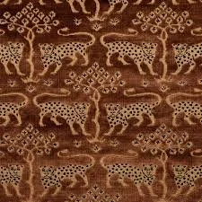Woodland Leopard Velvet by Schumacher, featuring a richly patterned leopard motif in warm tobacco brown with black and golden accents on plush velvet.
