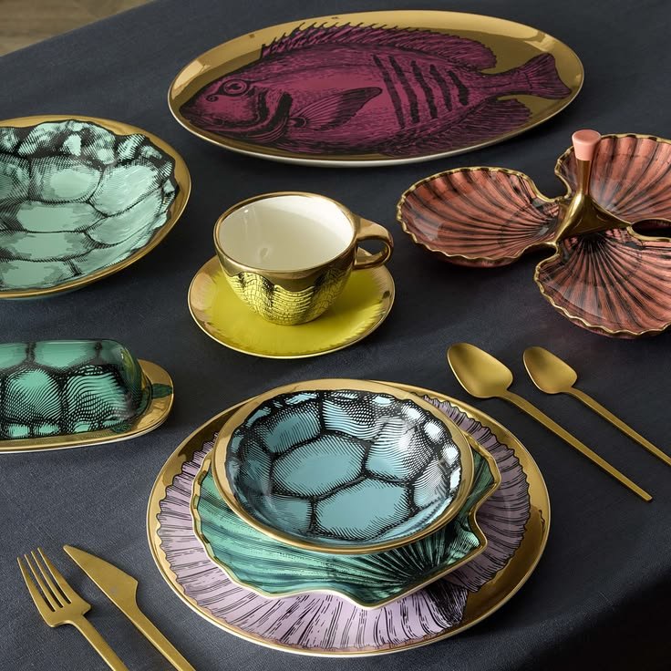 Jonathan Adler tableware featuring the Sirena Serving Platter. Colorful fish, botanical, and shell motifs meet graphic linework and gleaming gold accents.