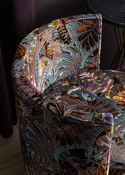 Chair upholstered in fabric from Brentano’s Evy Collection, shown through Altfield. Expressive botanical pattern and rich color bring visual depth and personality to an inviting seat.