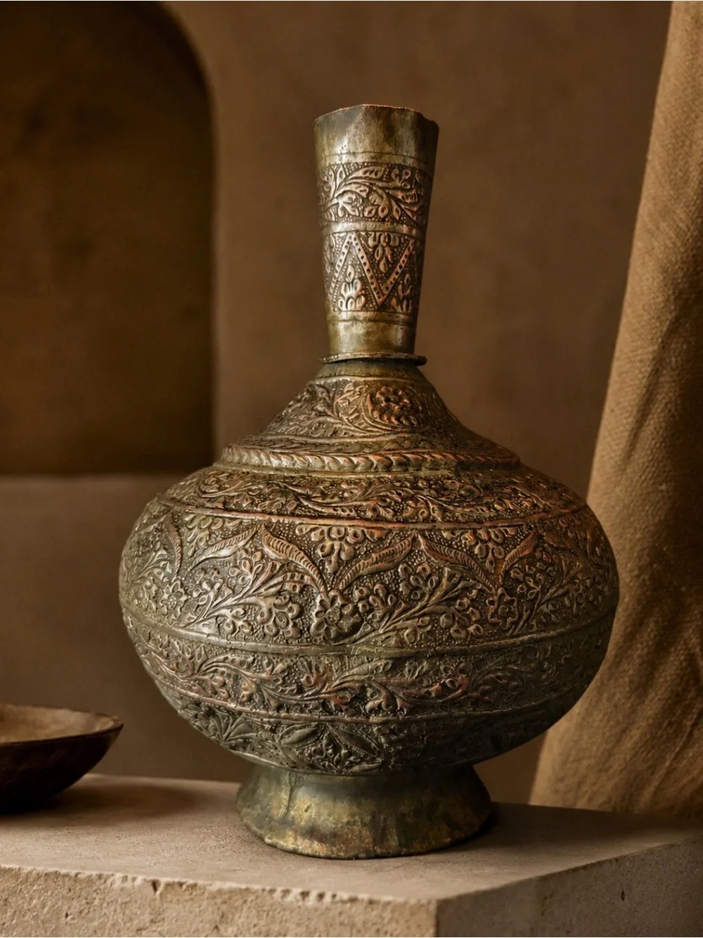 Antique Indo-Persian Tinned Copper Surahi, through Poshmark. Intricate floral decoration, a slender neck, and softly aged metallic tones bring craftsmanship and sculptural elegance to a collected interior.