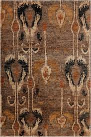 Hetty Hand Knotted Jute / Sisal Ikat Area Rug by Chandra Rugs, featuring an earthy brown, rust and black motif with the rich texture and character of hand-knotted natural fibers.