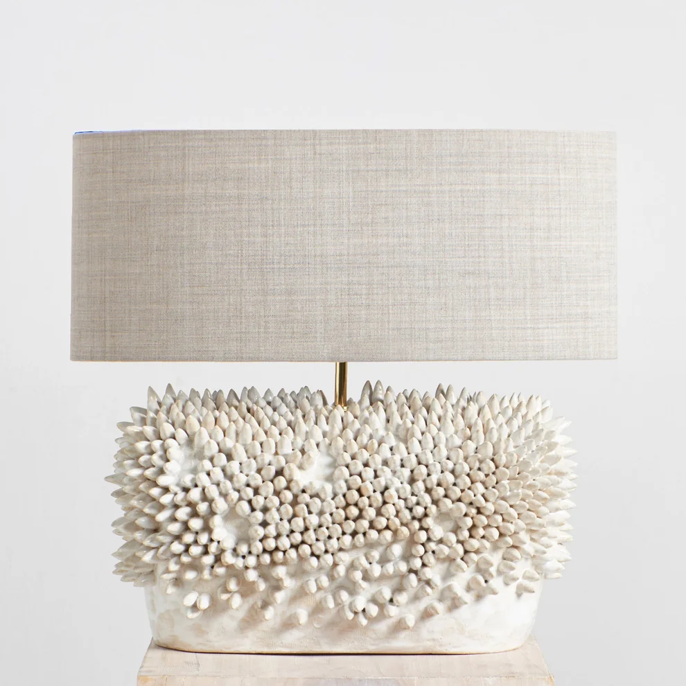 Appuntito Ceramic Light in White by Project 213A, featuring a sculptural hand-textured ceramic base and neutral linen shade.