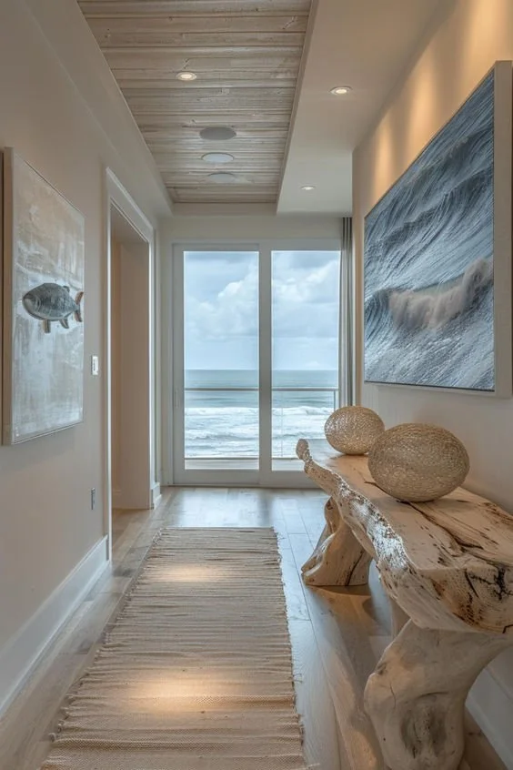 Coastal interior with ocean view, natural wood console and relaxed neutral textures