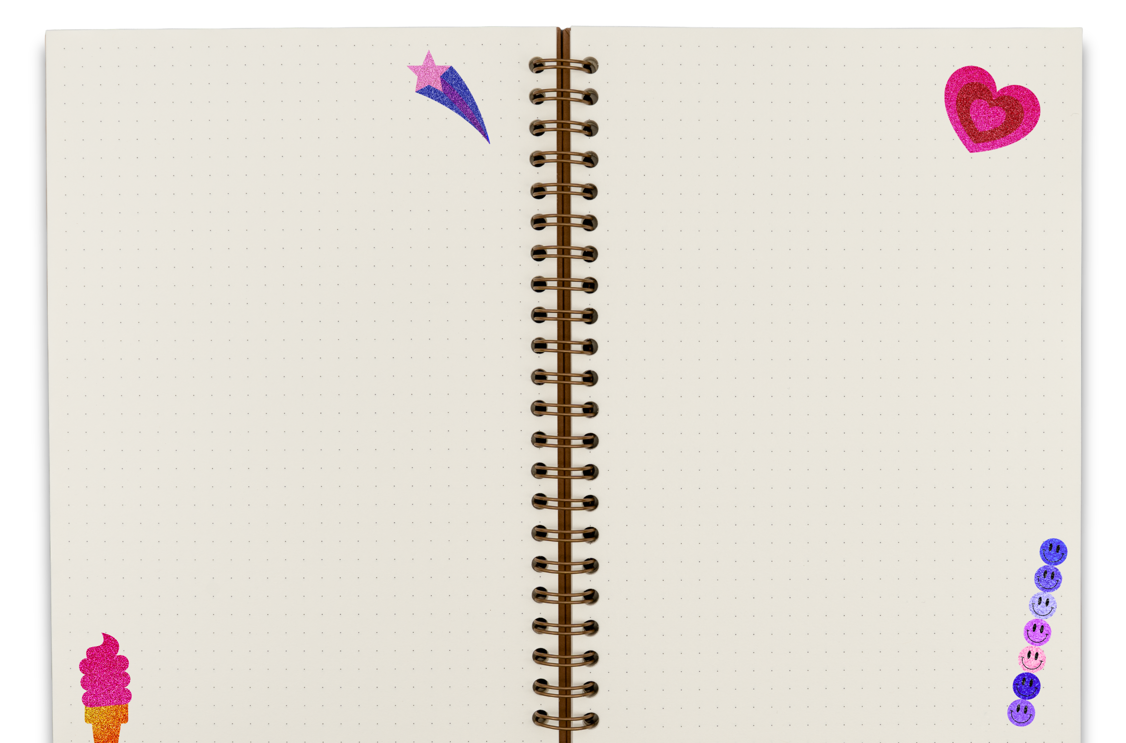 Open notebook with dotted pages decorated with colorful stickers, including a pink ice cream cone at the bottom left, a pink and purple shooting star at the top, a pink heart with purple hearts on the top right, and a vertical line of purple, pink, and blue smiley face stickers on the right side.