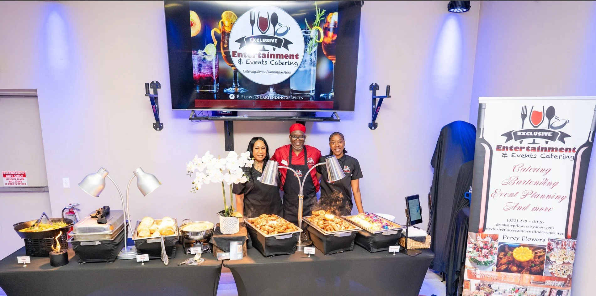 Owner and two employees in front of buffet.