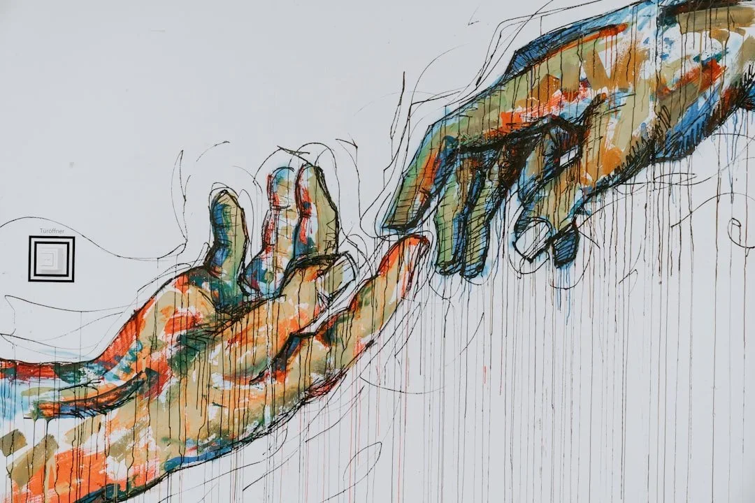 A colorful abstract painting of two hands reaching toward each other on a white background, with paint dripping down from the fingers and expressive, sketch-like outlines.