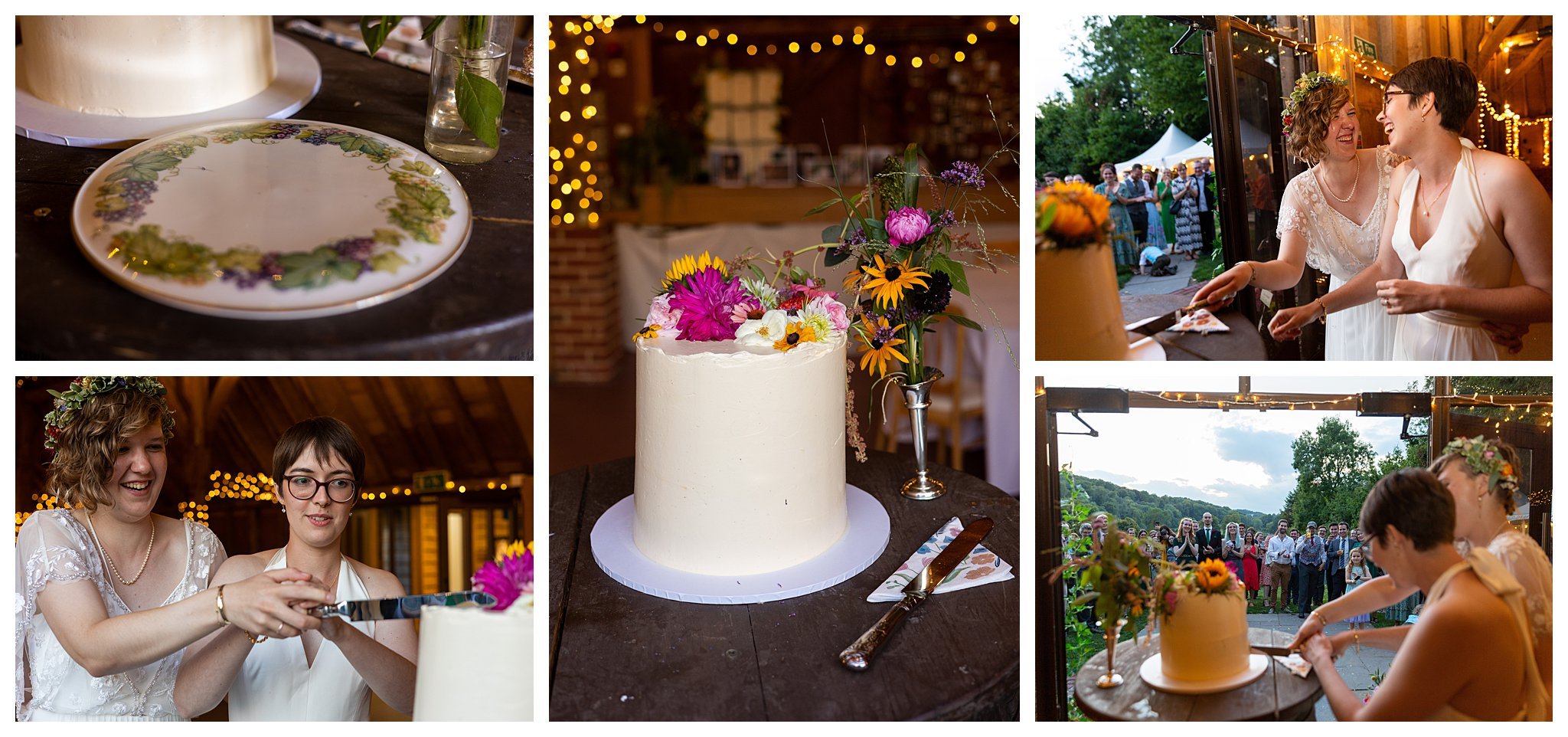 Bright and colourful flowers on top of a plain cake at Gilbert Whites house and Barn while the brides cut it surrounded by guests. They're relaxed and laughing