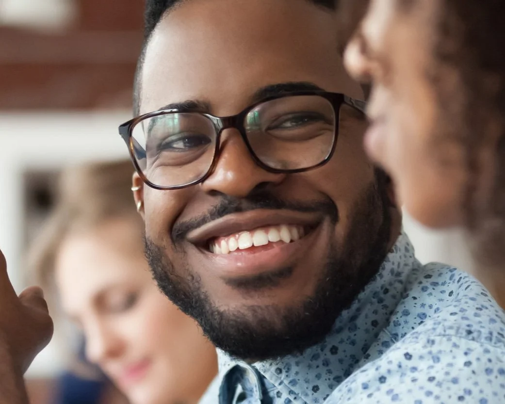 Photo of coworkers in office setting.