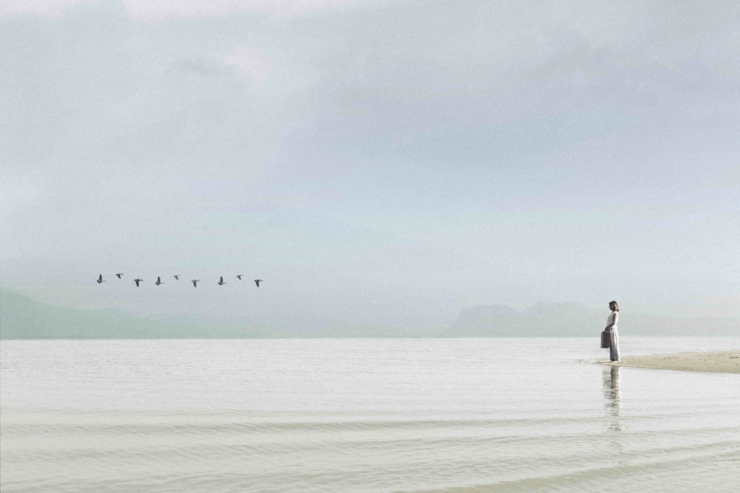 Woman standing by a lake