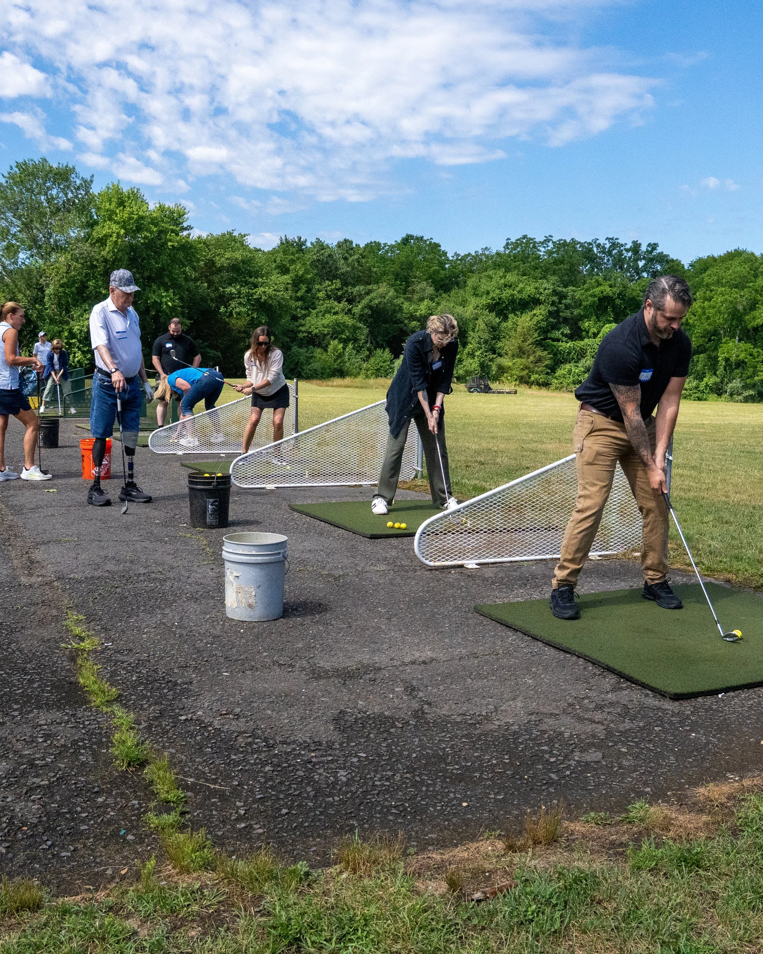  Physical therapists and occupational therapists learning adaptive golf techniques with Lou Namm of the Eastern Amputee Golf Association 