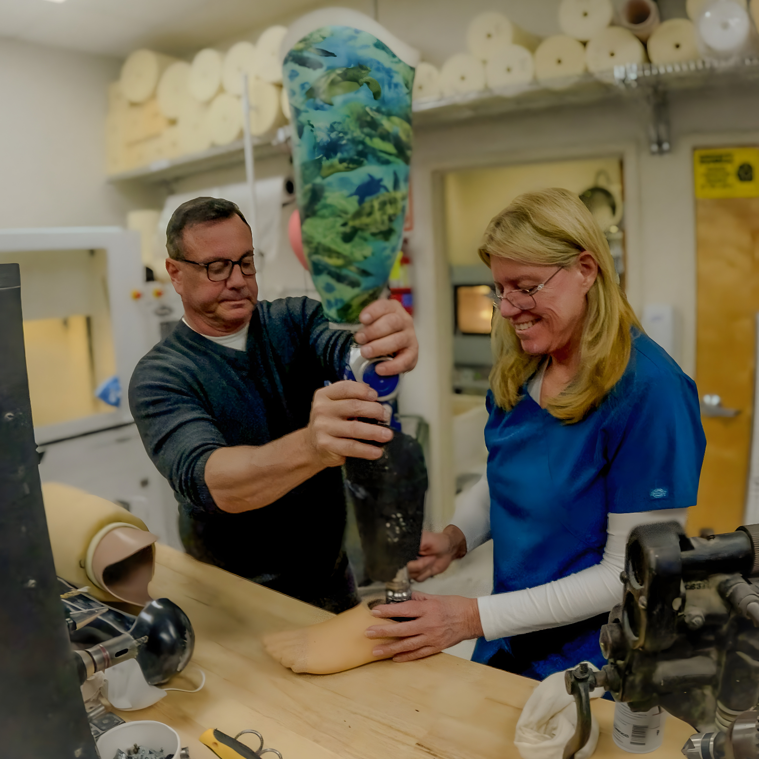 Bob and Jean Manfredi fabricating a custom prosthetic leg in the Manfredi O&P Eatontown shop