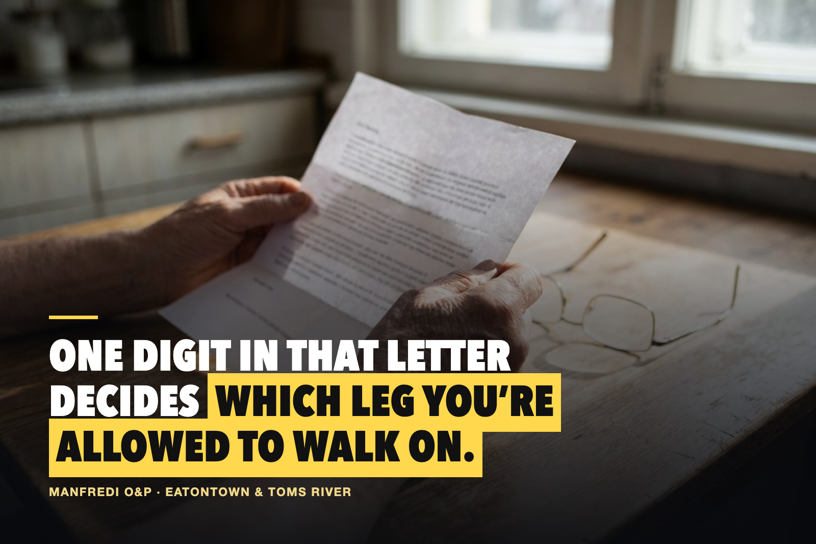 An amputee reads a Medicare K-level letter at a kitchen table, captioned: one digit in that letter decides which leg you're allowed to walk on.