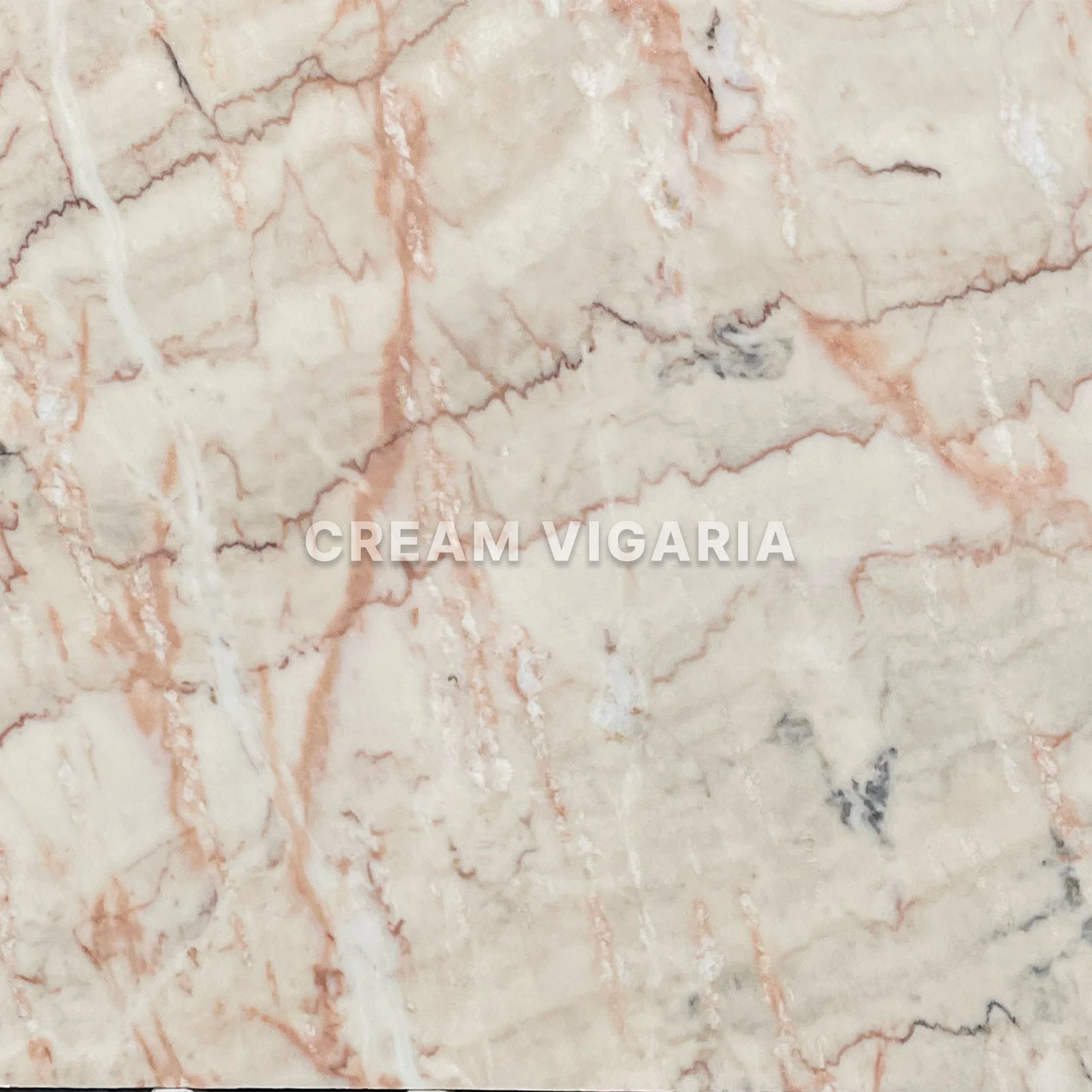 Close-up of a cream-colored marble surface with pink and black veining, with the words 'CREAM VIGARIA' superimposed.