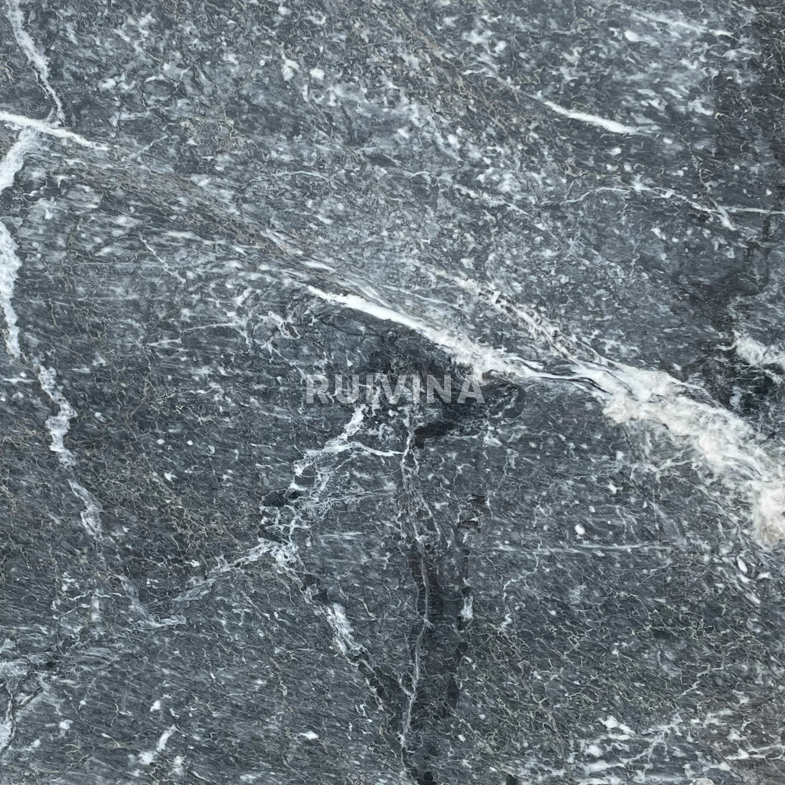 Close-up of a dark grey marble surface with white veining and text 'RUIHINA' in the center.