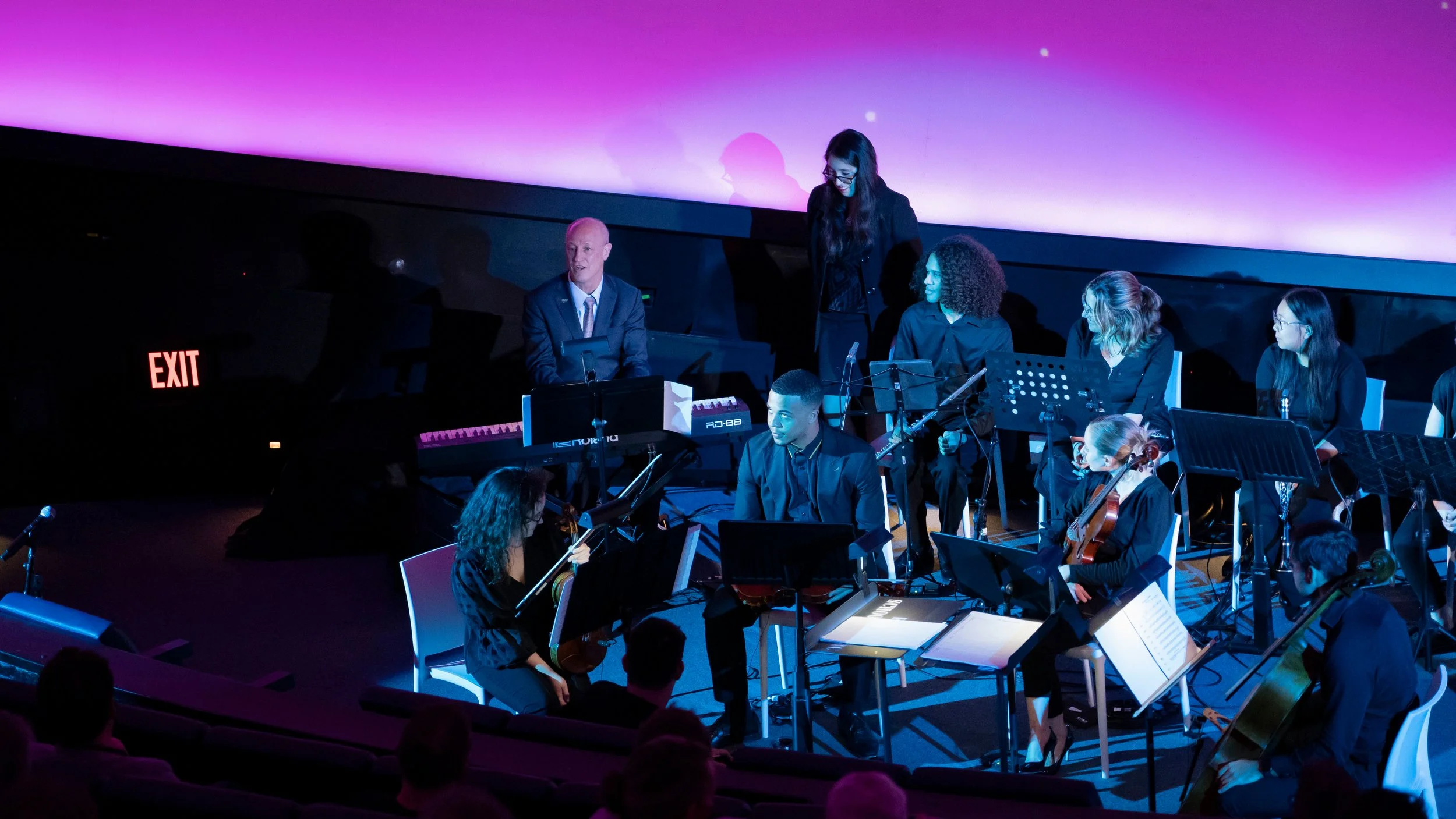 Planetarium with dean on piano.jpg