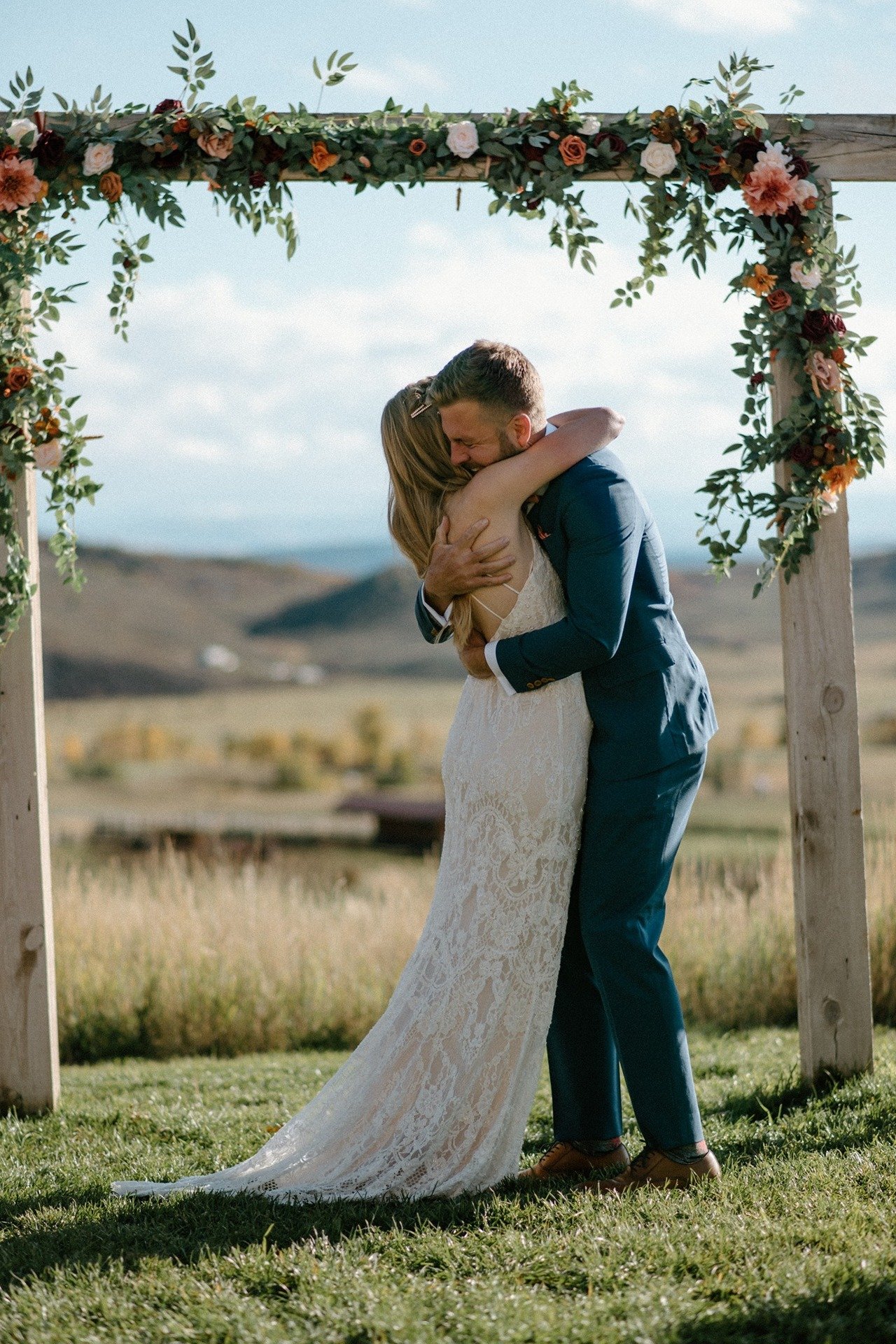 bride-groom-hugging-under-arch.jpg
