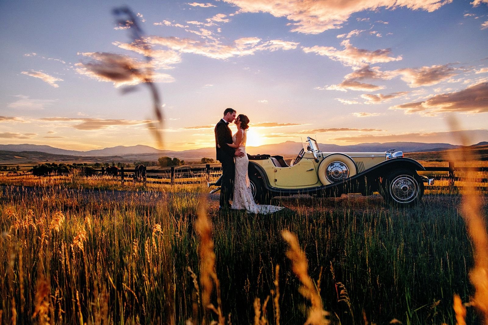 couple-kissing-with-vintage-car-at-sunset.jpg