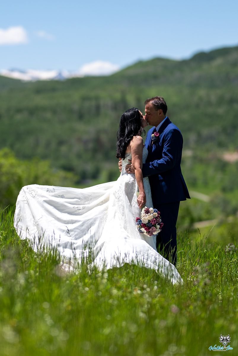 Couple kissing in mountain grass