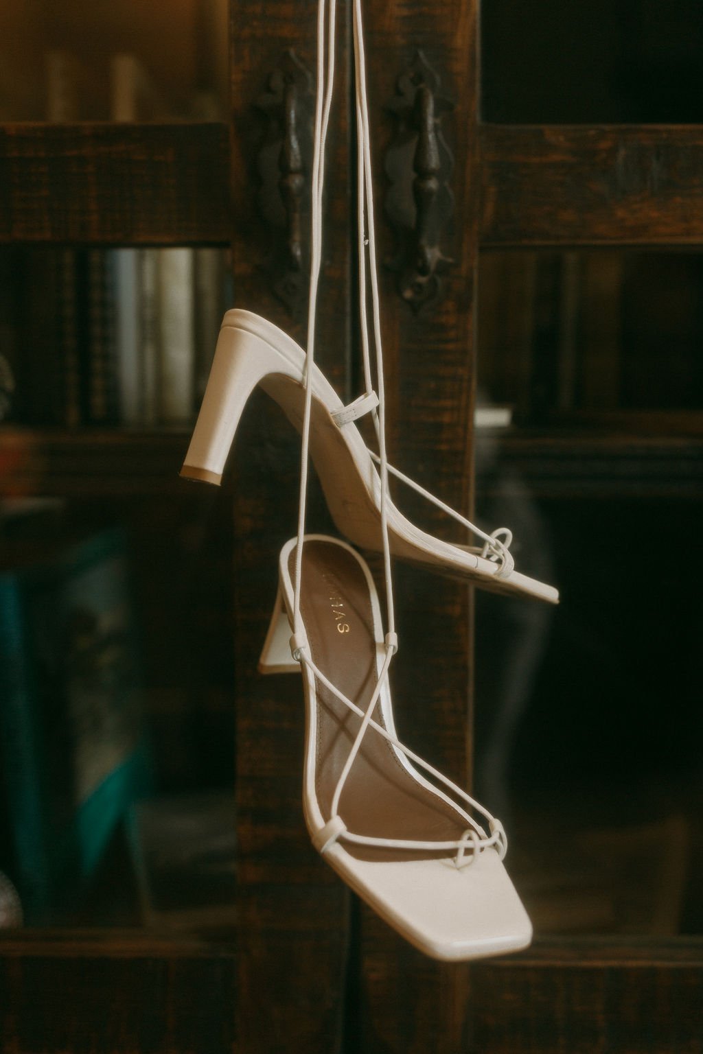  Wedding shoes hanging from vintage bookcase at La Joya Dulce Steamboat Springs 
