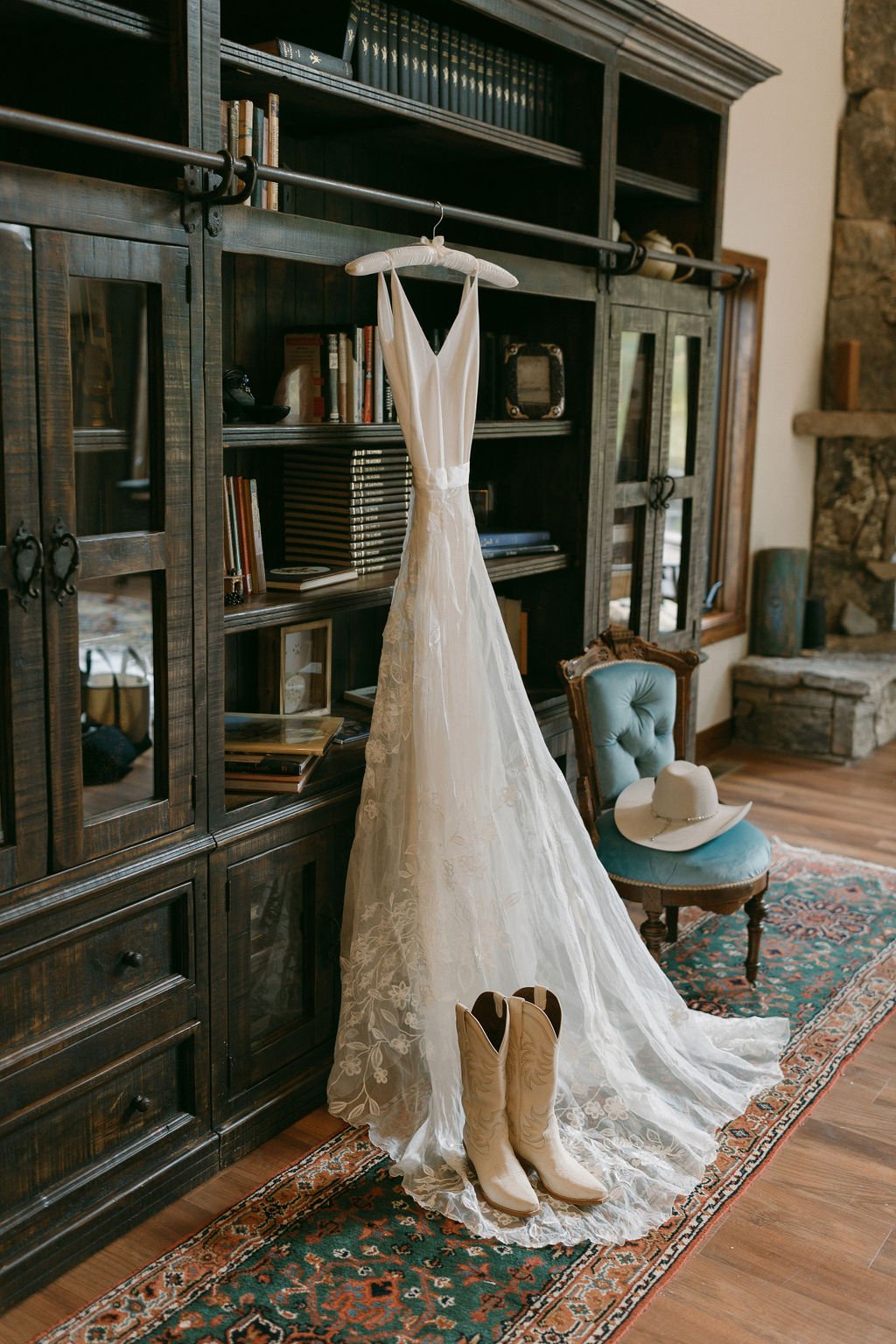  Wedding gown, boots and hat hanging from vintage bookcase at La Joya Dulce Steamboat Springs 