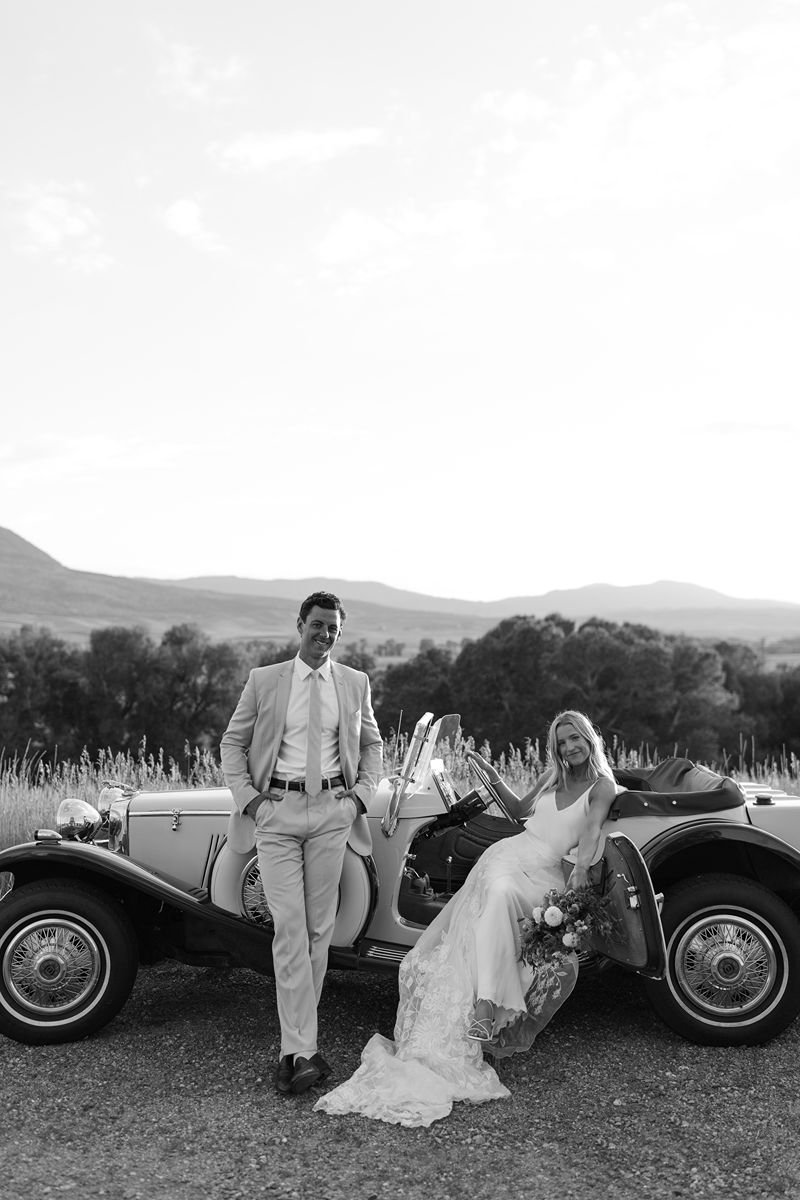 Couple with vintage jaguar car